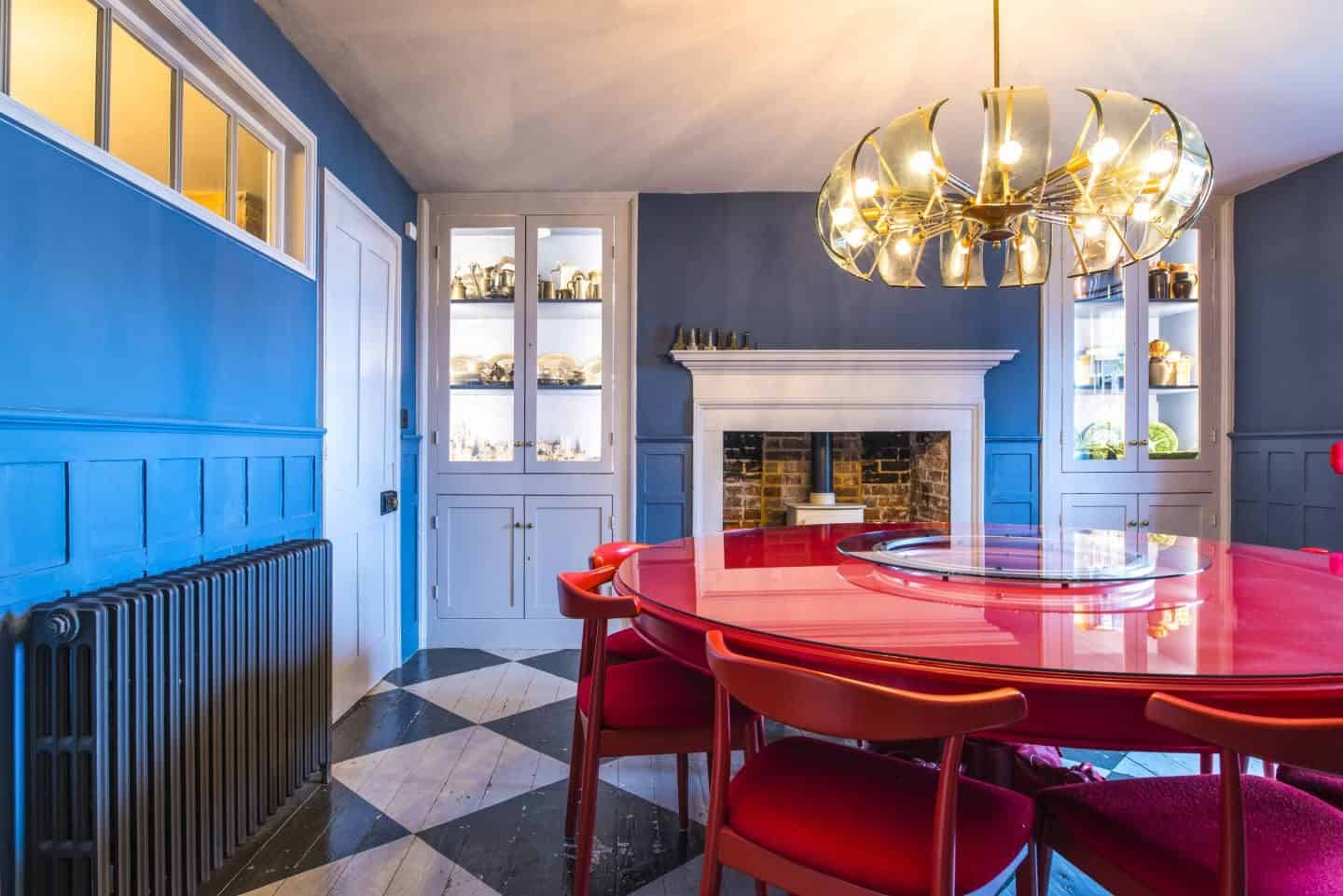 Image from the book Love Colour ©annastarmer - A blue dining room with red table and chairs