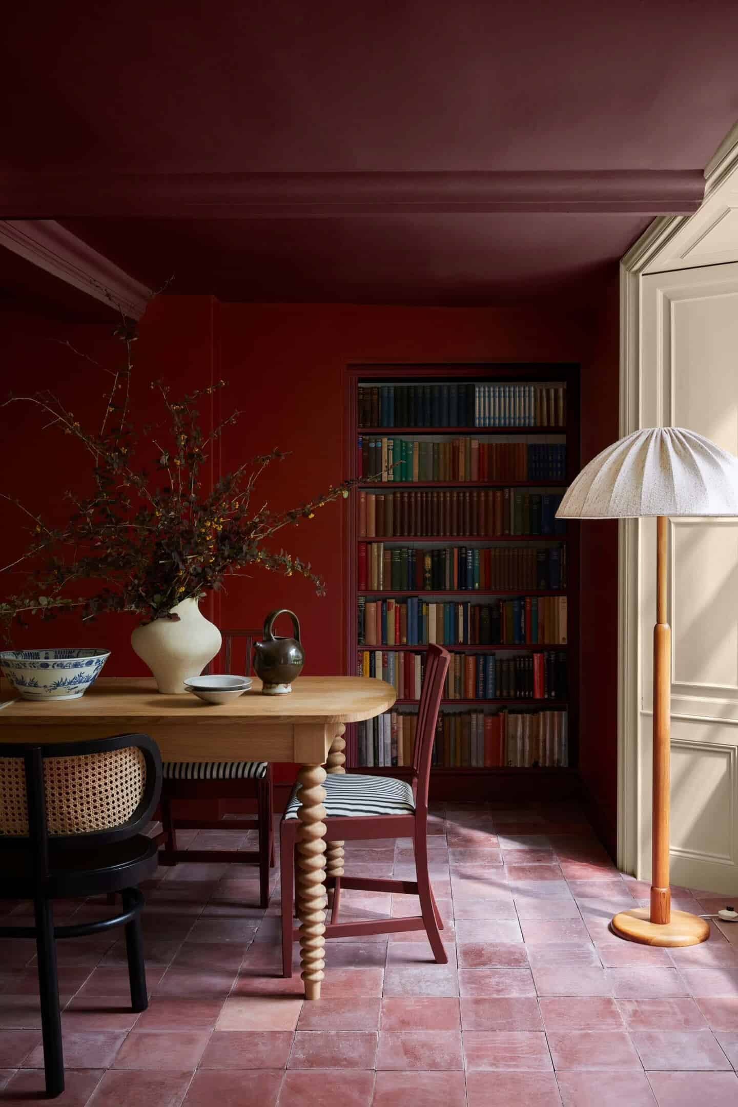 Double-drenched dining room painted in dark red paint from Little Greene