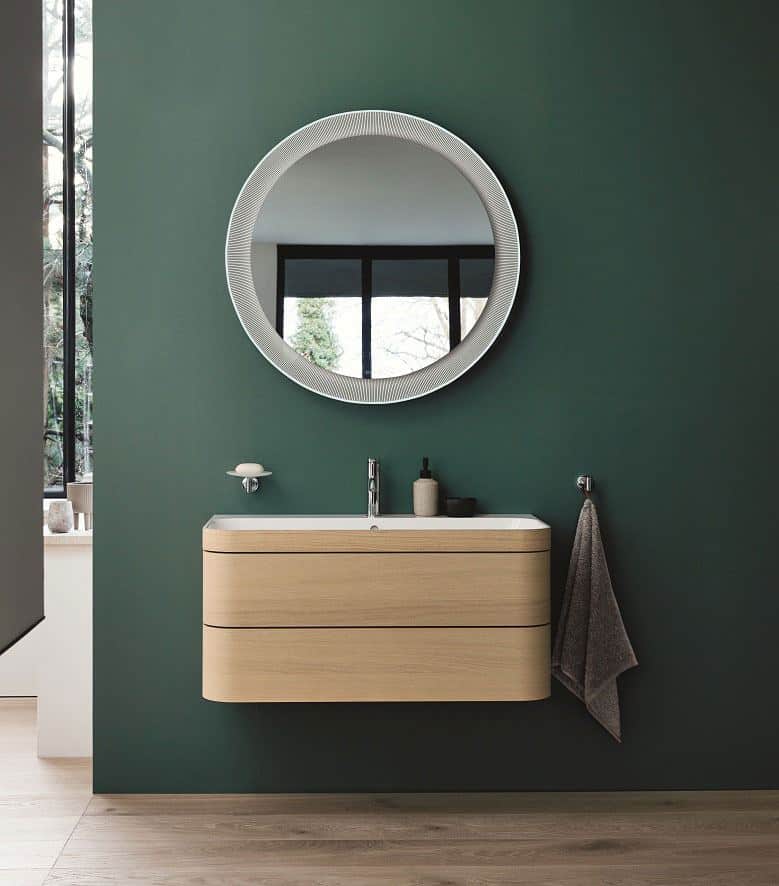 Duravit Happy D.2 Plus C-Shaped bathroom range. Wall-mounted vanity unit with two drawers and large circular mirror above.