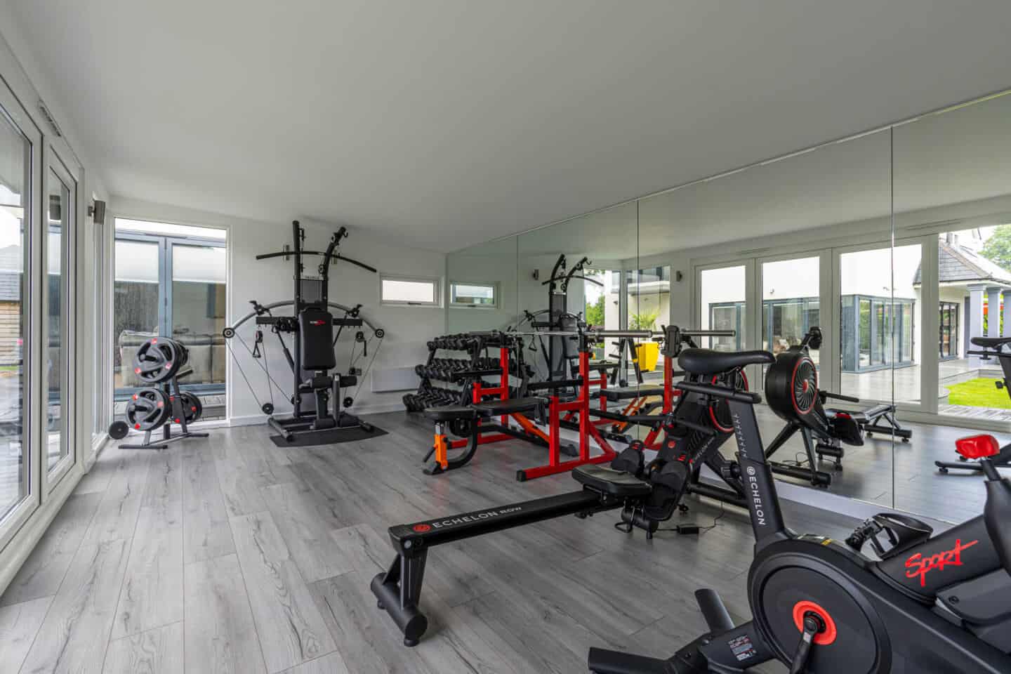 Home gym full of workout equipment and machinery 