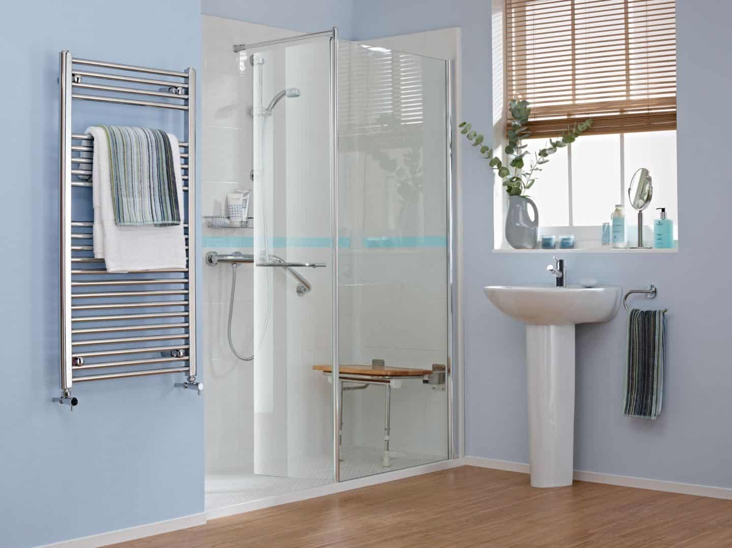 Accessible bathroom design from Premier Care Bathrooms. A walk-in shower feturing integrated shower seat and grab rails.