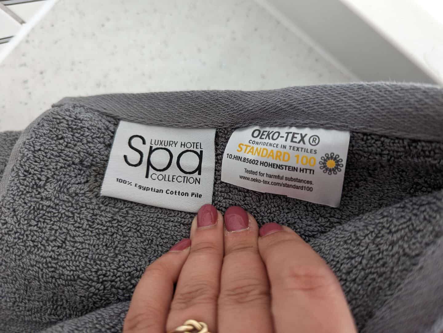 Labels on a grey Egyptian Cotton Bath Towel showing Oeko-Tex 100 standard