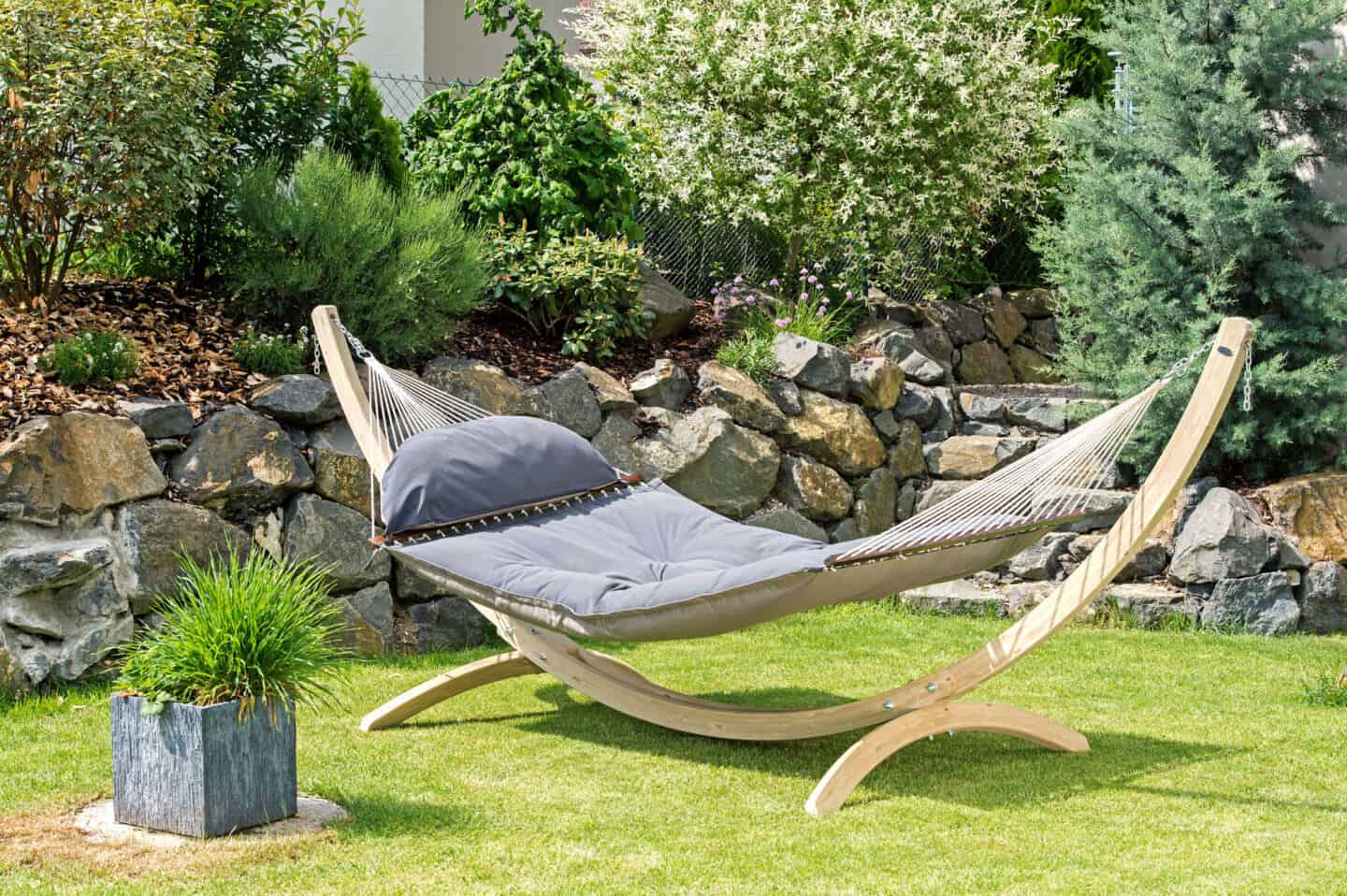 A grey hammock in a garden