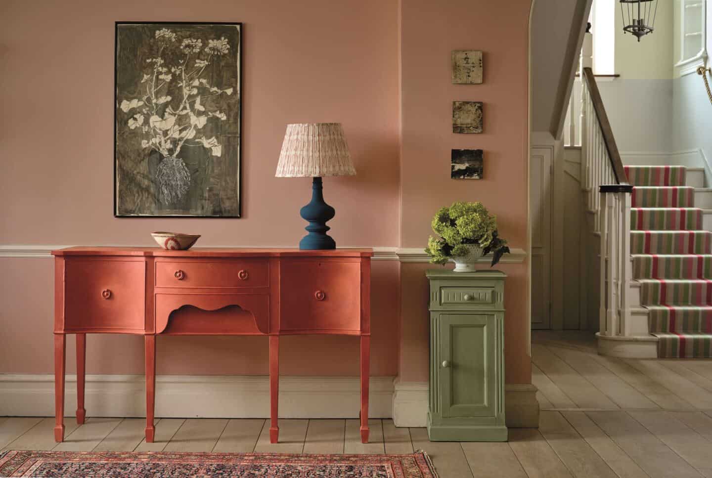 An upcycled piece of furniture painted in paprika paint by Annie Sloane in a hallway