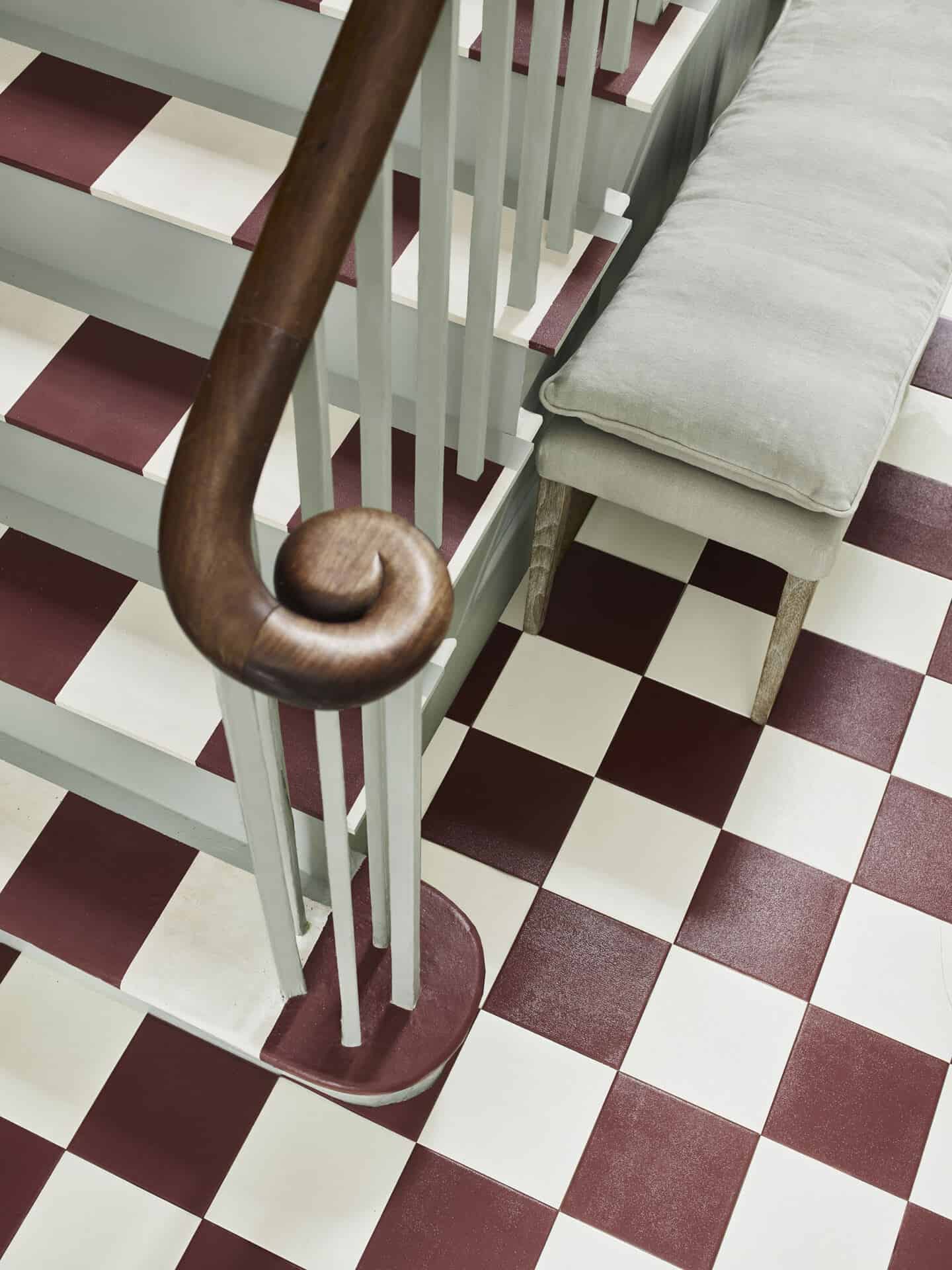 A staircase with red and white painted squares that look like tiles