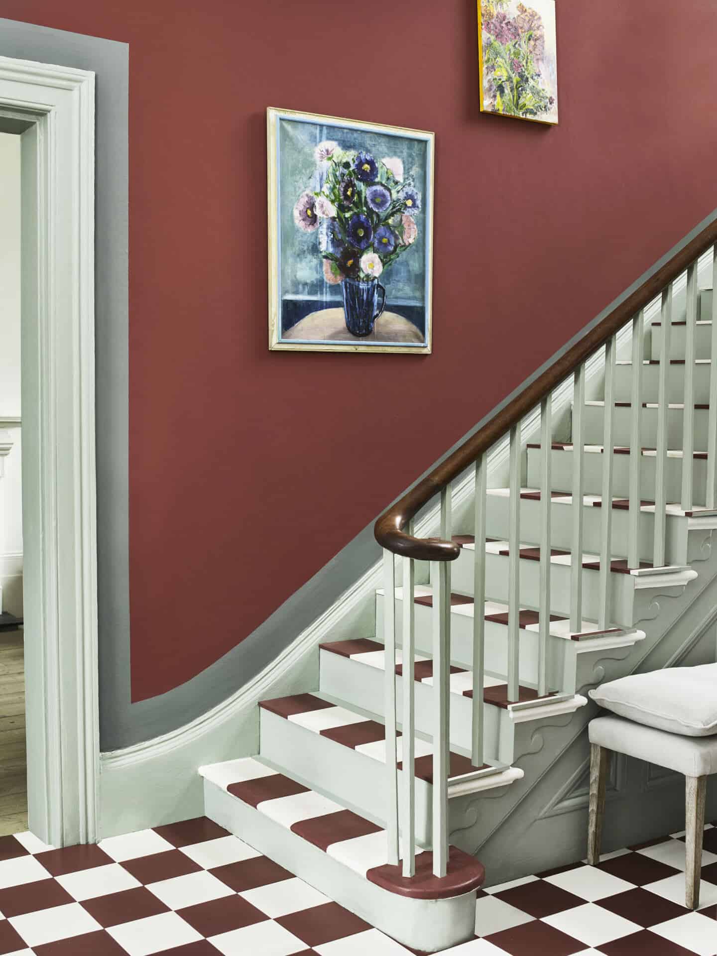 A staircase with red and white painted squares that look like tiles