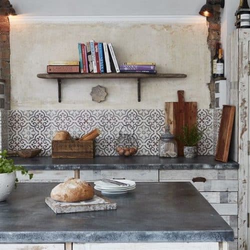 Reclaimed or antique tiles on a kitchen floor and used as a splashback - Maitland & Poate