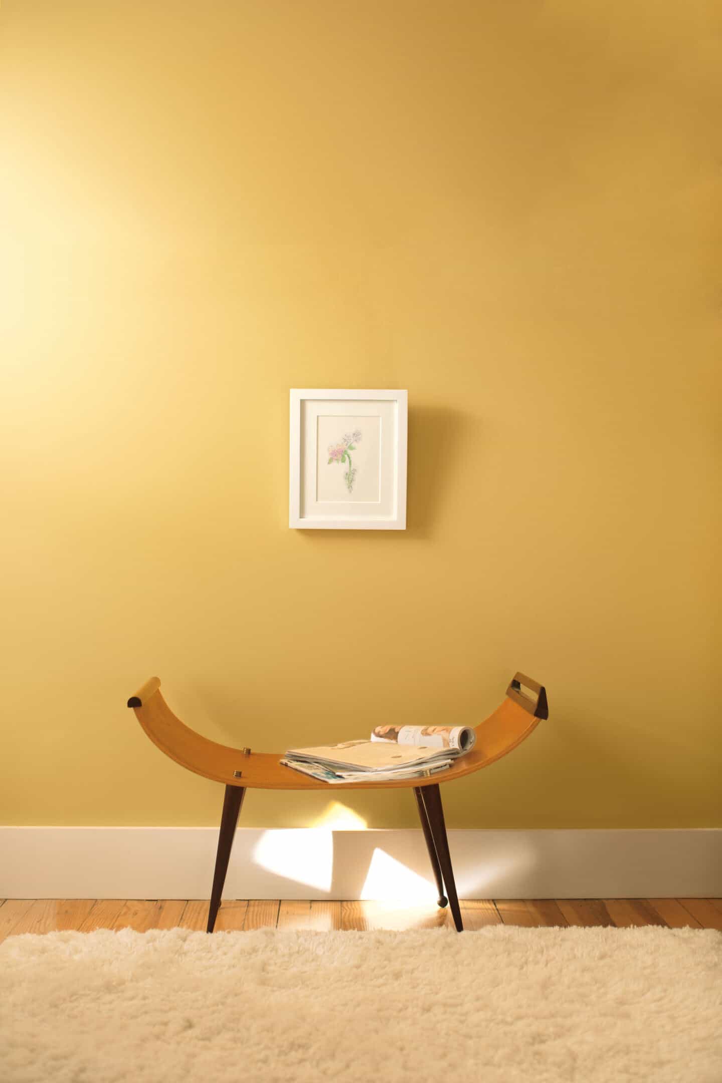 Pantone Colour of the Year 2021 - Illuminating. The colour psychology behind using yellow in interiors. A wall painted in Aurora York Harbour Yellow from Benjamin Moore