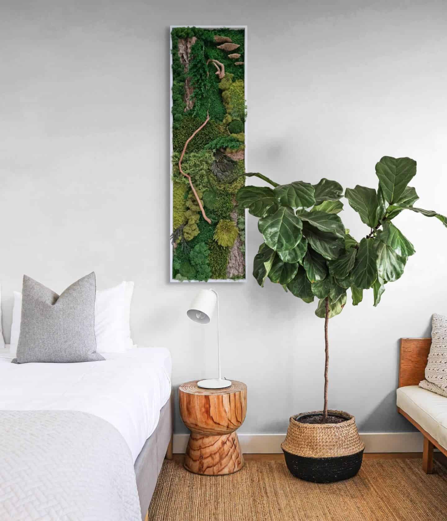 Biophilic moss wall art hanging on the wall in a modern minimalist bedroom