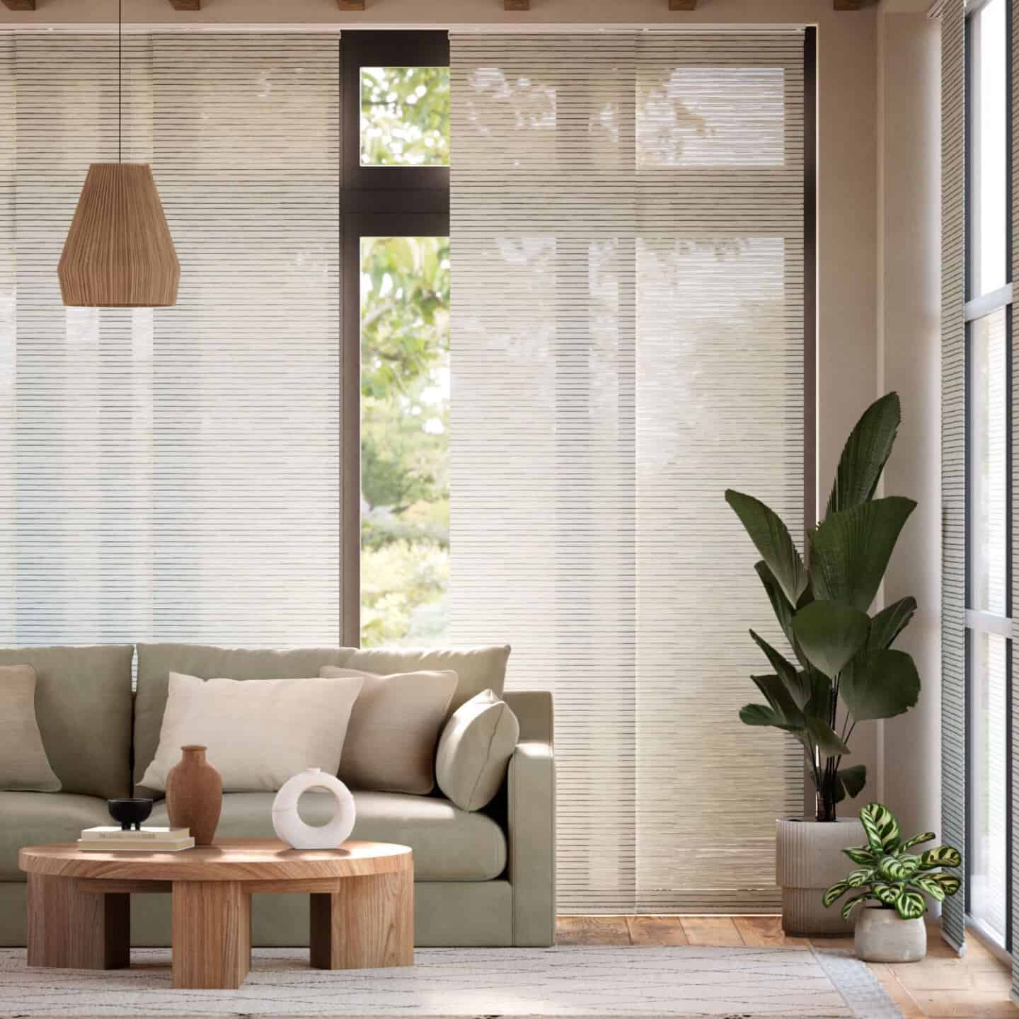 A neutral minimalist living room with floor to ceiling windows covered by linen panels