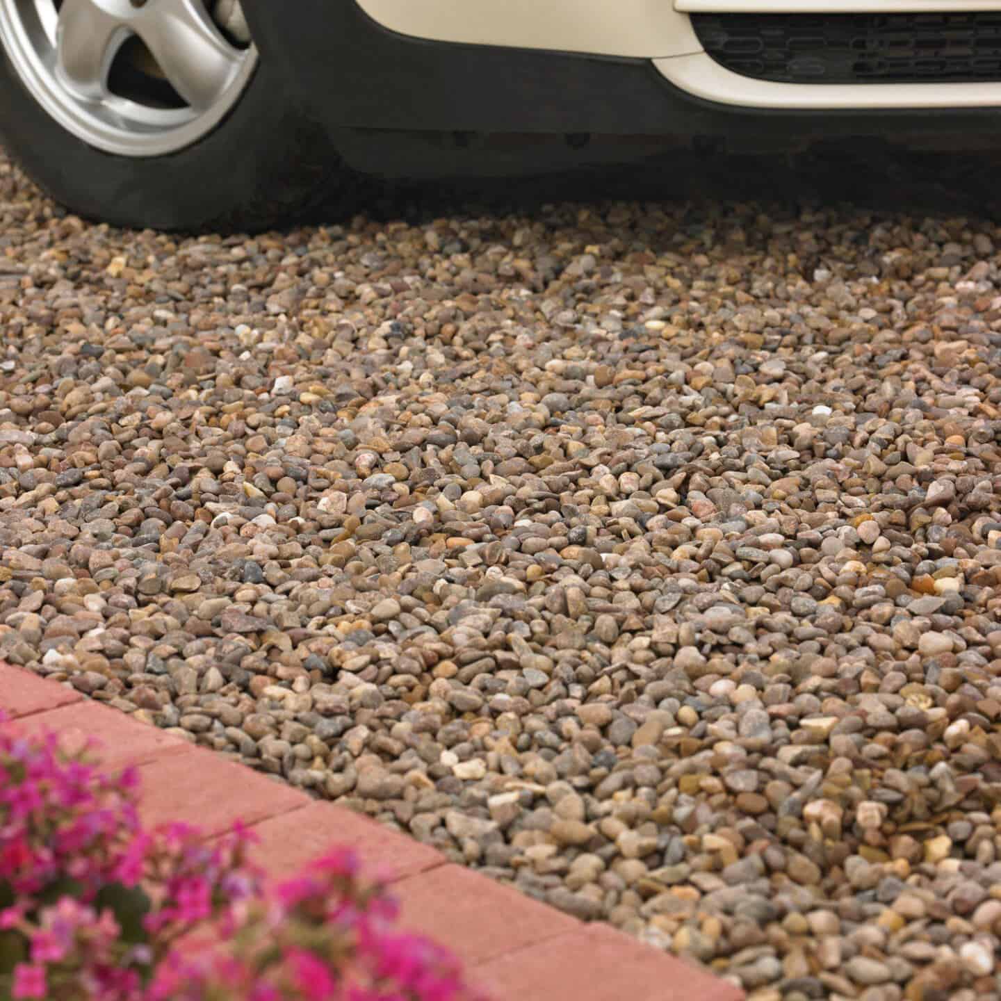 A car parked on rounded brown decorative stones