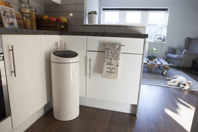 brabantia white touch bin situated in a modern monochrome kitchen