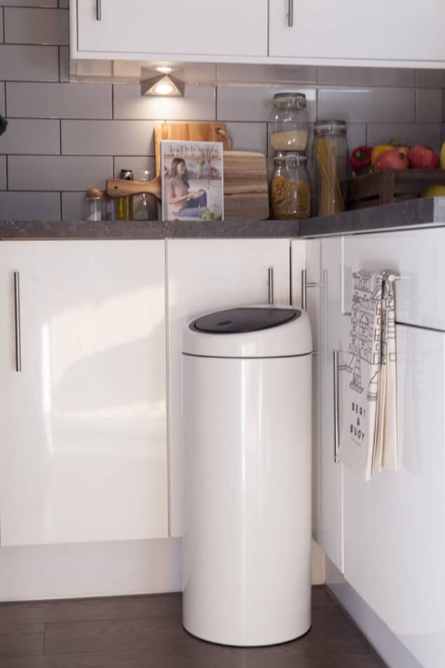 brabantia white touch bin situated in a modern monochrome kitchen