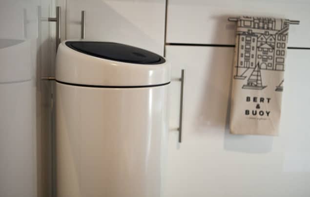 brabantia white touch bin situated in a modern monochrome kitchen