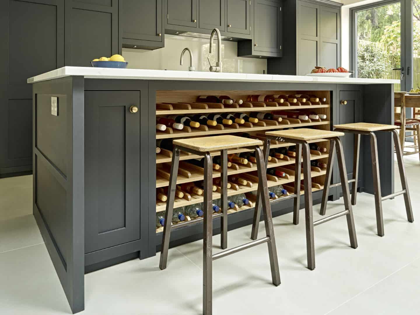 A black shaker style kitchen island with wine rack.