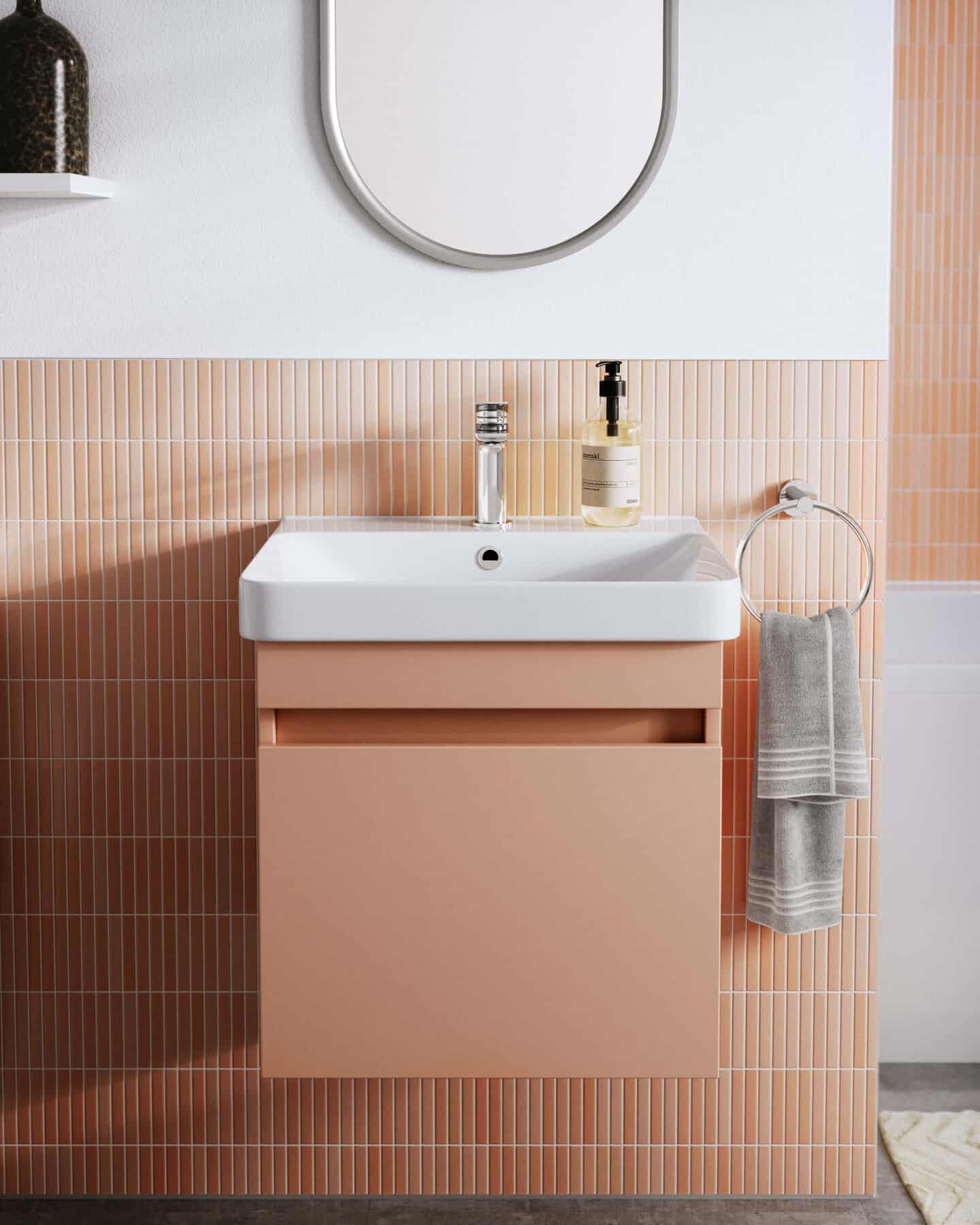 A bathroom basin in Pantone colour of the year 2024 Peach Fuzz