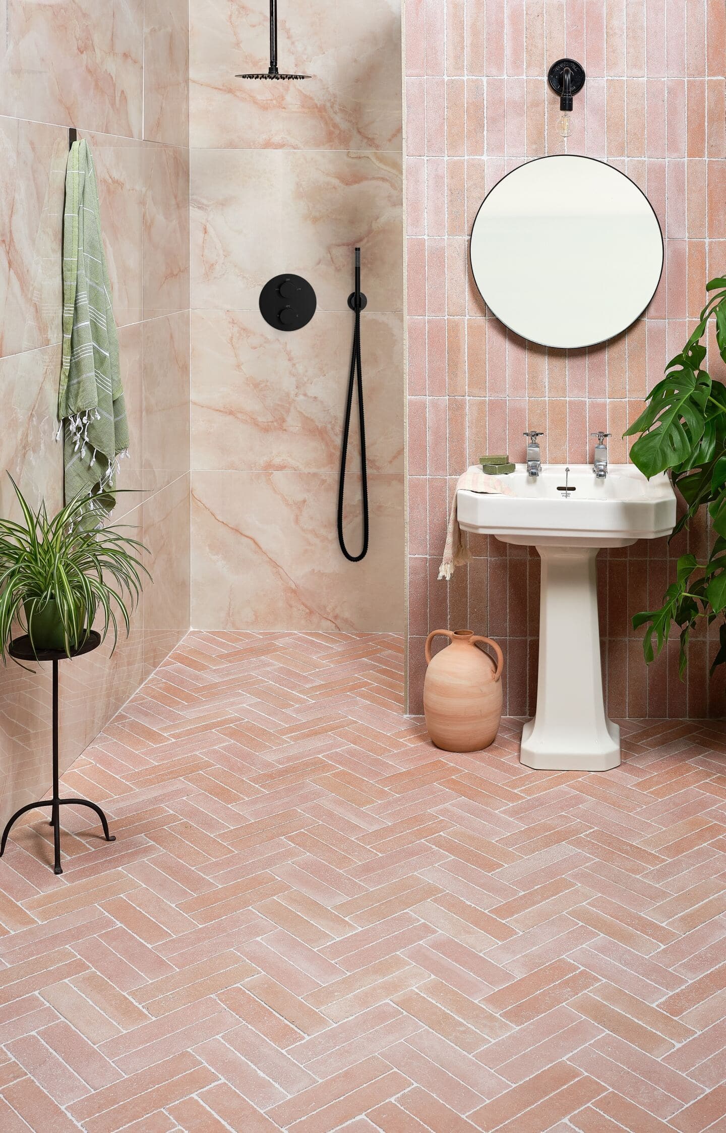 A bathroom featuring pink wall and floor tiles in a similar shade to Pantone Colour of the Year 2024 Peach Fuzz