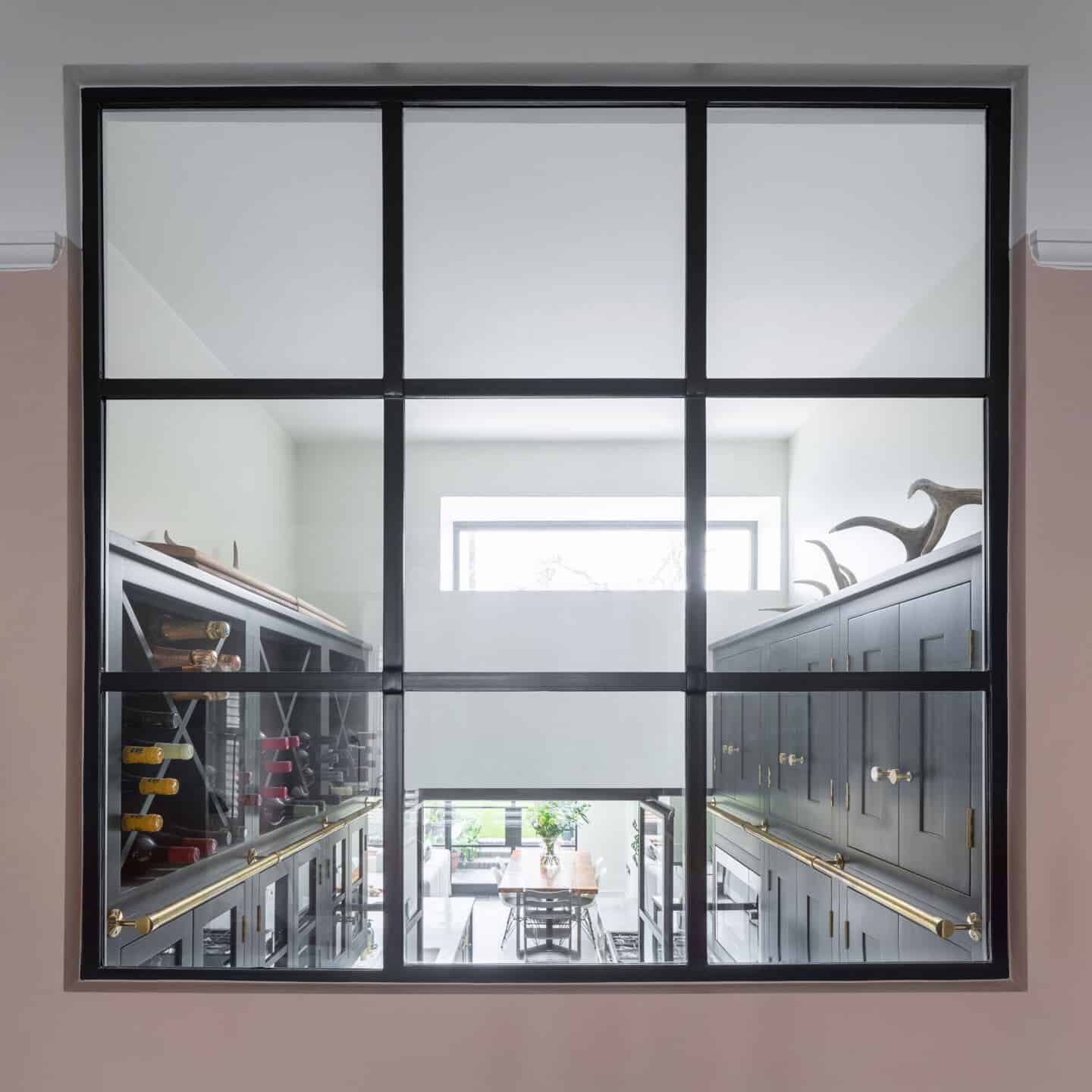 A view through an internal window into the kitchen area below