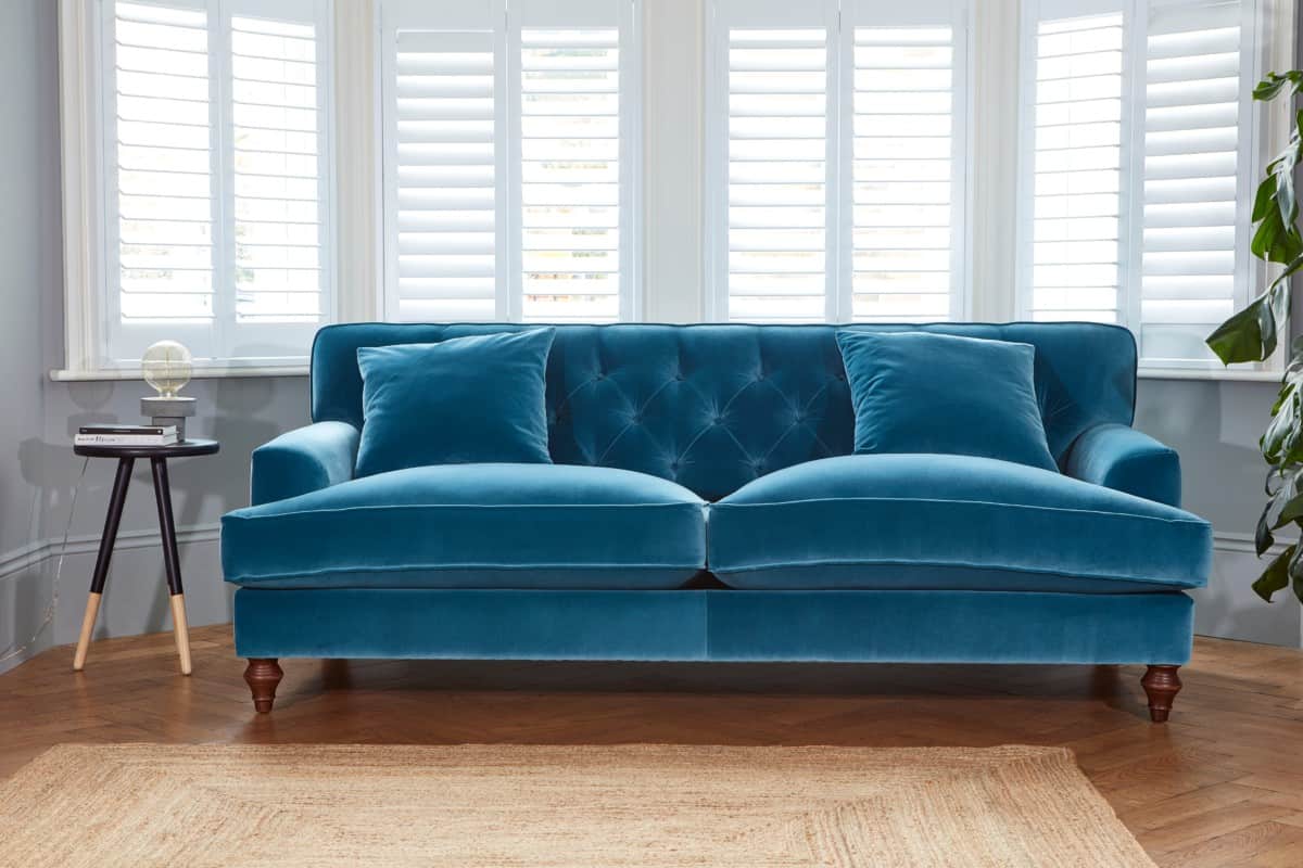 Traditional button back blue velvet sofas from Darlings of Chelsea