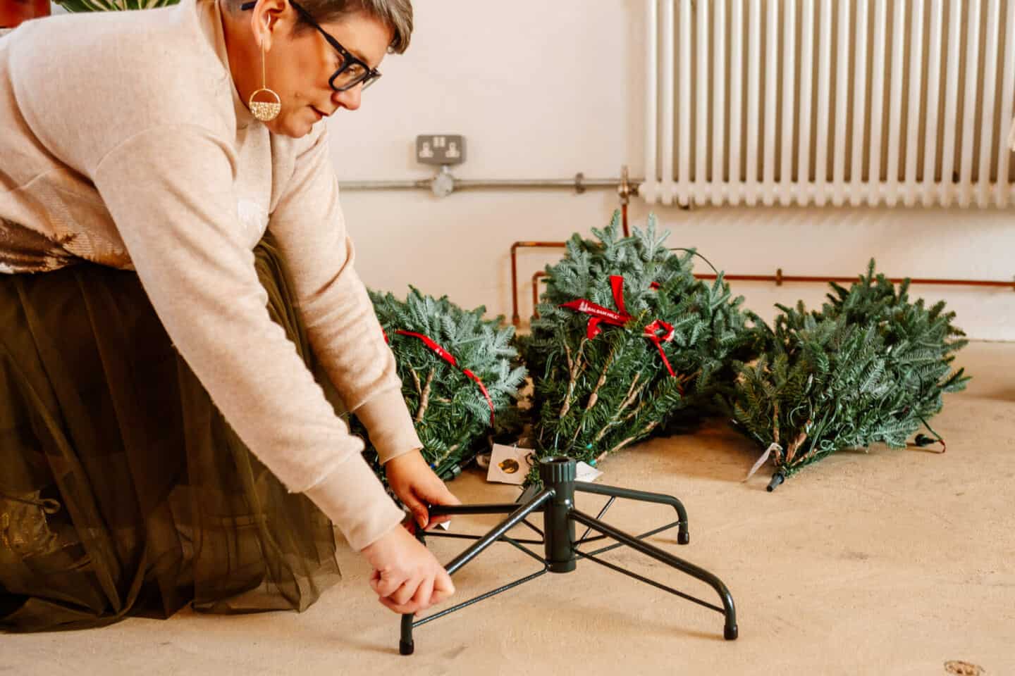 A woman in her forties constructs a realistic Christmas tree from Balsam Hill