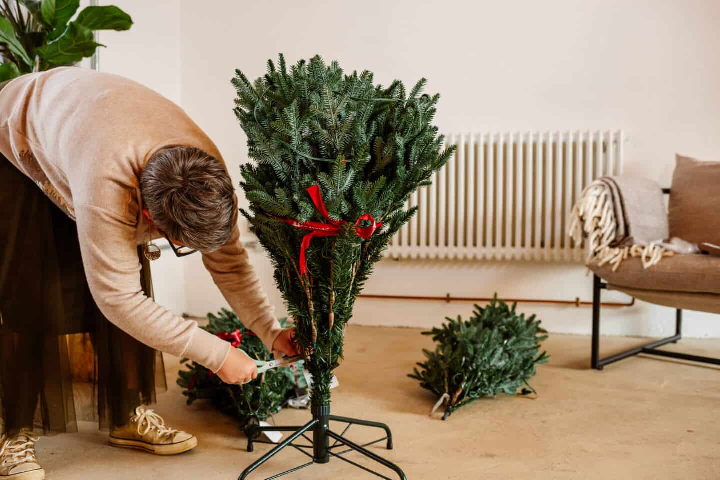 A woman in her forties constructs a realistic Christmas tree from Balsam Hill