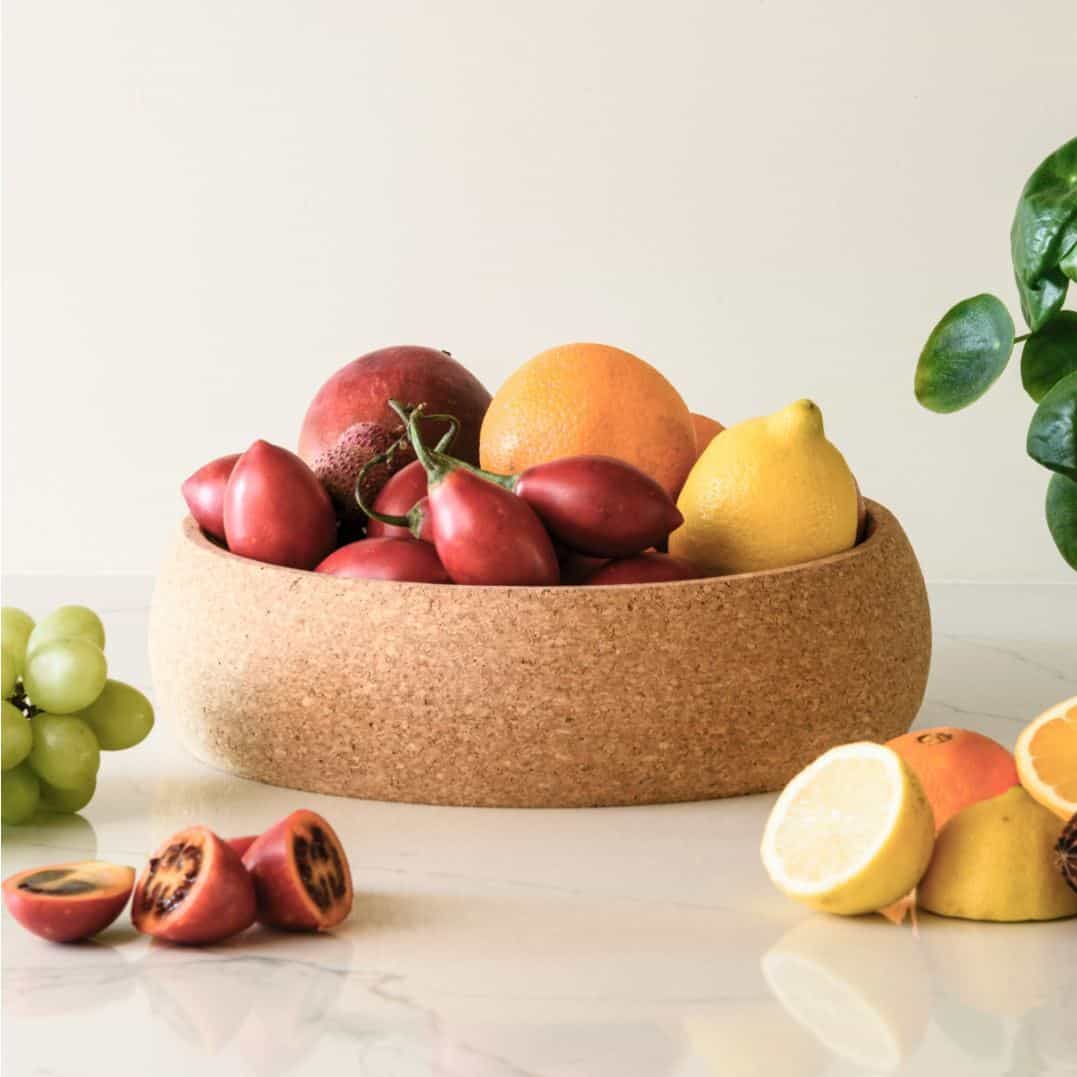 Fruit in a cork bowl on a marble work surface