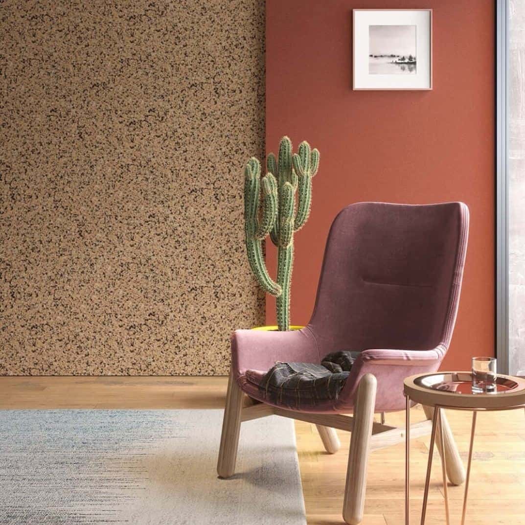 A chair and coffee table in front of a wall covered in cork