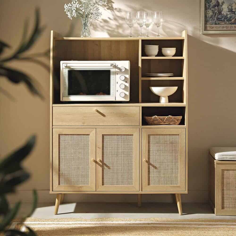 A freestanding cabinet in the kitchen houses crockery and a microwave to help make a more functional kitchen