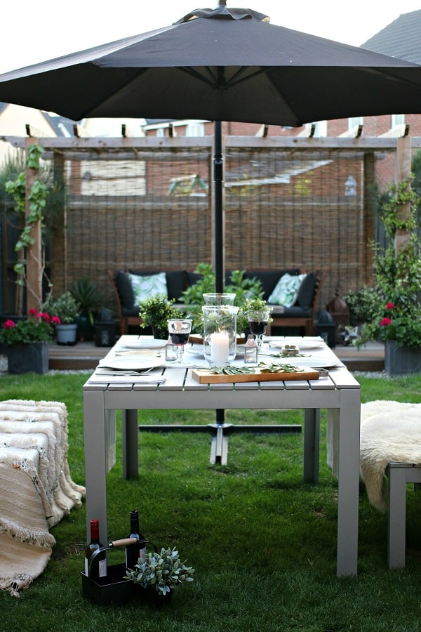 Dear Designers garden style featuring dining table, throws, sheepskins and candles