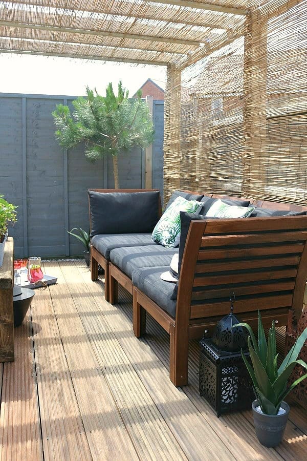 Dear Designers garen makeover featuring pergola, reed screening, outdoor sofa