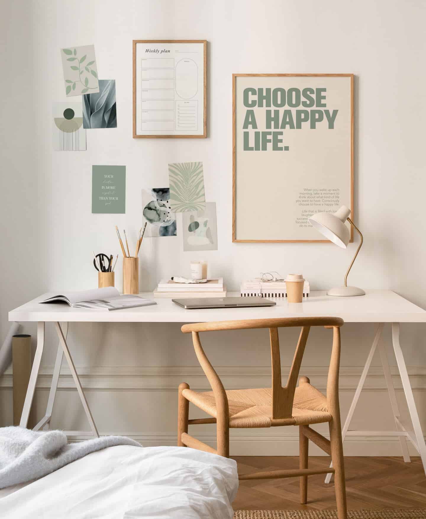 A gallery wall of images and pictures hung above a desk