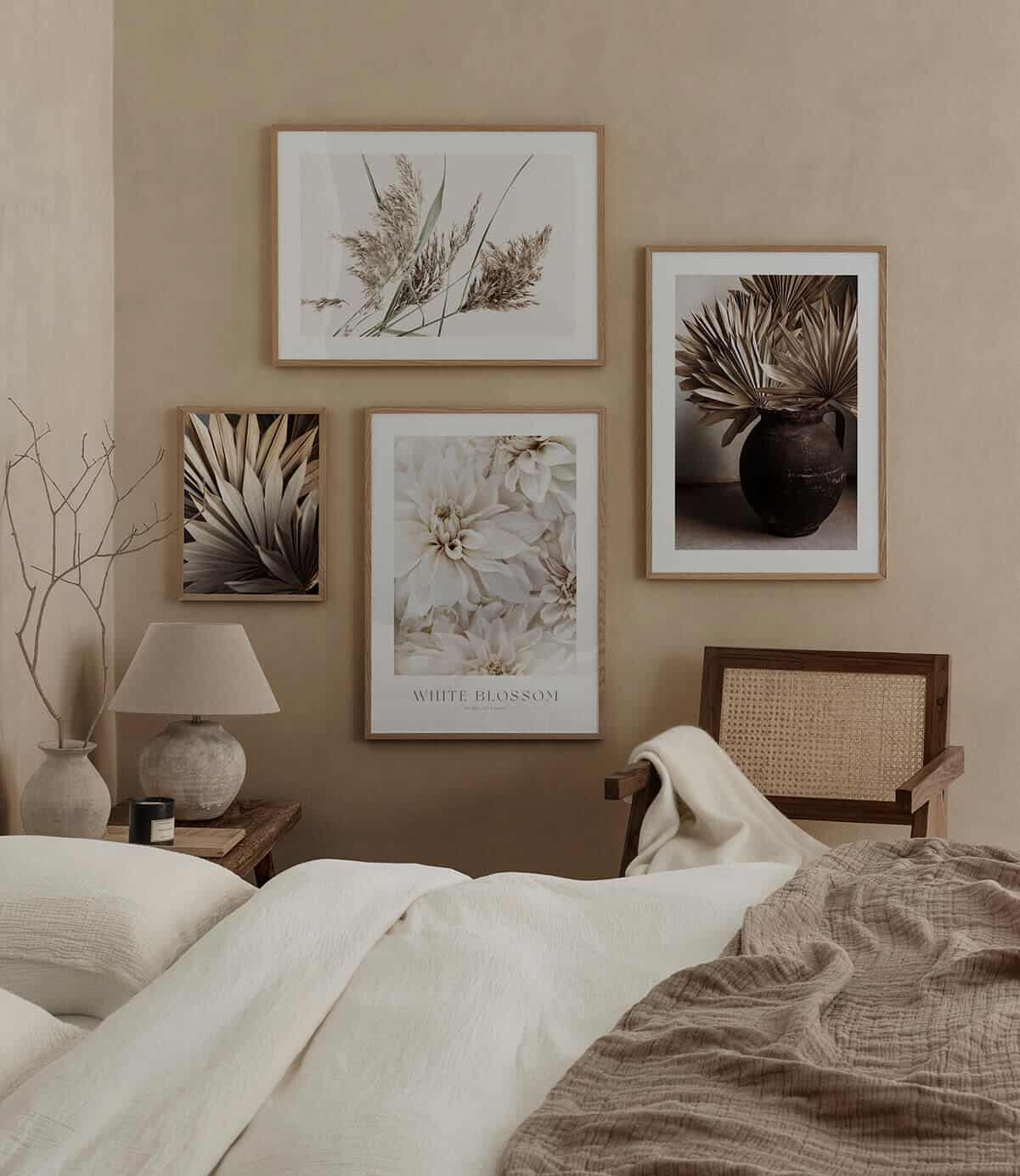 A gallery wall of nature-inspired artwork on a beige bedroom wall