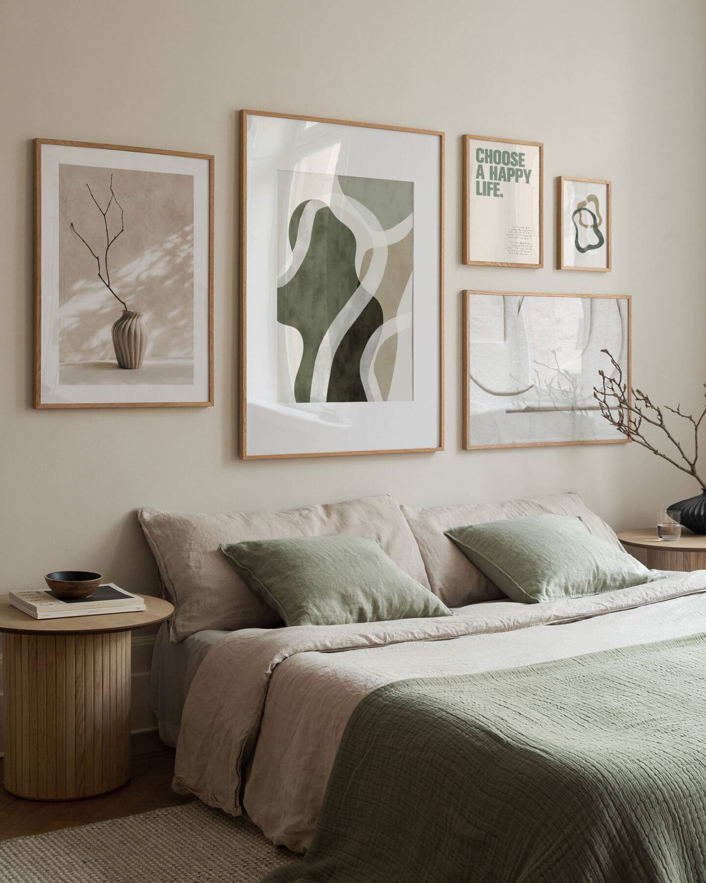 An elegant minimalist bedroom featuring beige and green linen bedding and a gallery wall of green and neutral Desenio artwork above the bed 