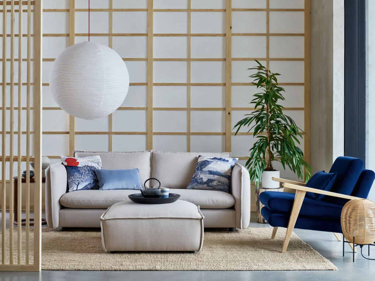 Japandi living room from DFS featuring paper screens and minimal grey sofa and pouffe