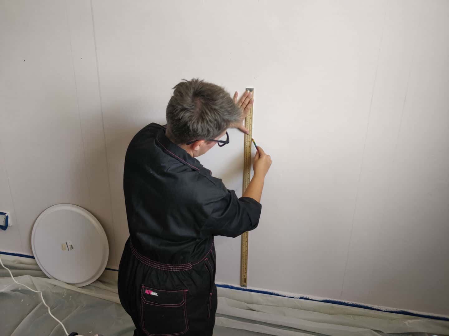 Blogger Stacey Sheppard drawing out the design for the DIY Painted Arch Accent Wall