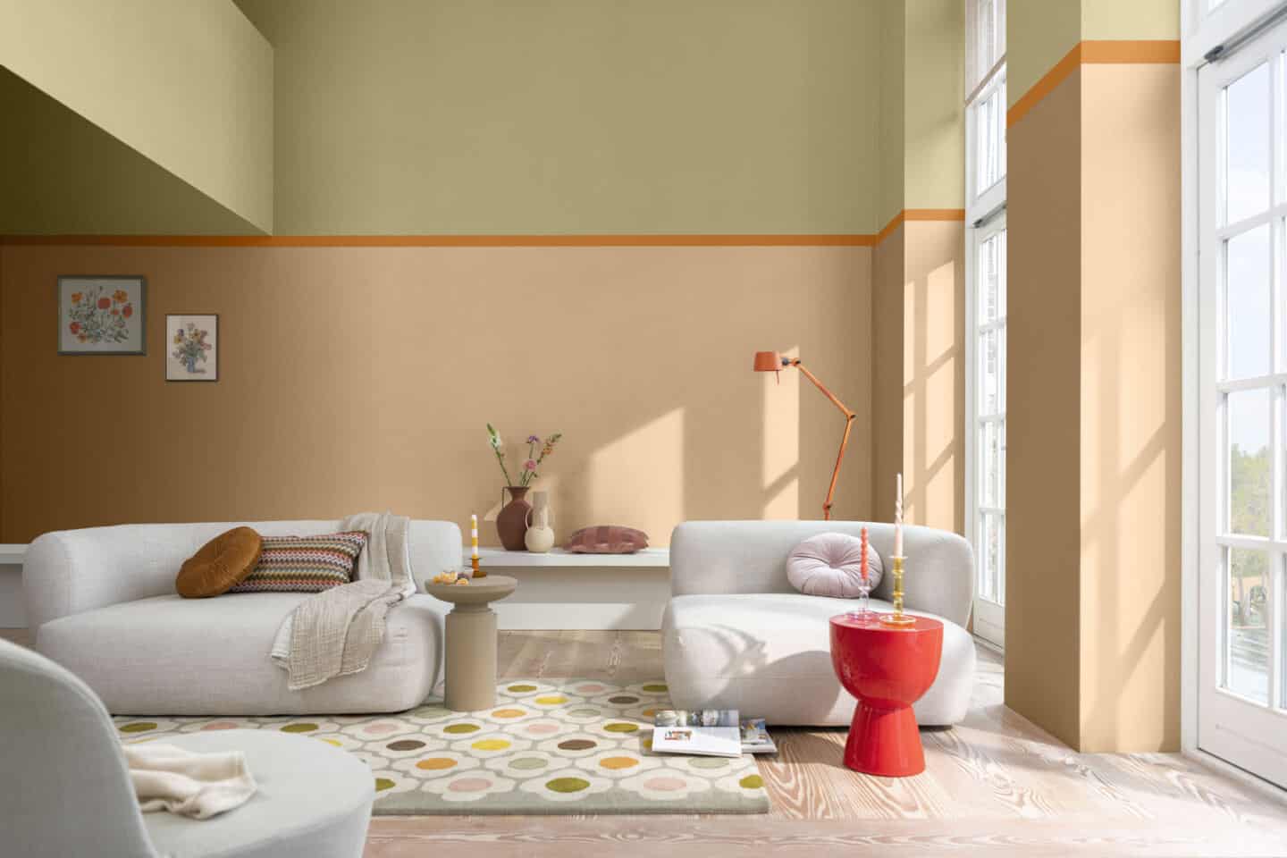 A light-filled modern living room with walls painted in shades of orange and yellow. 