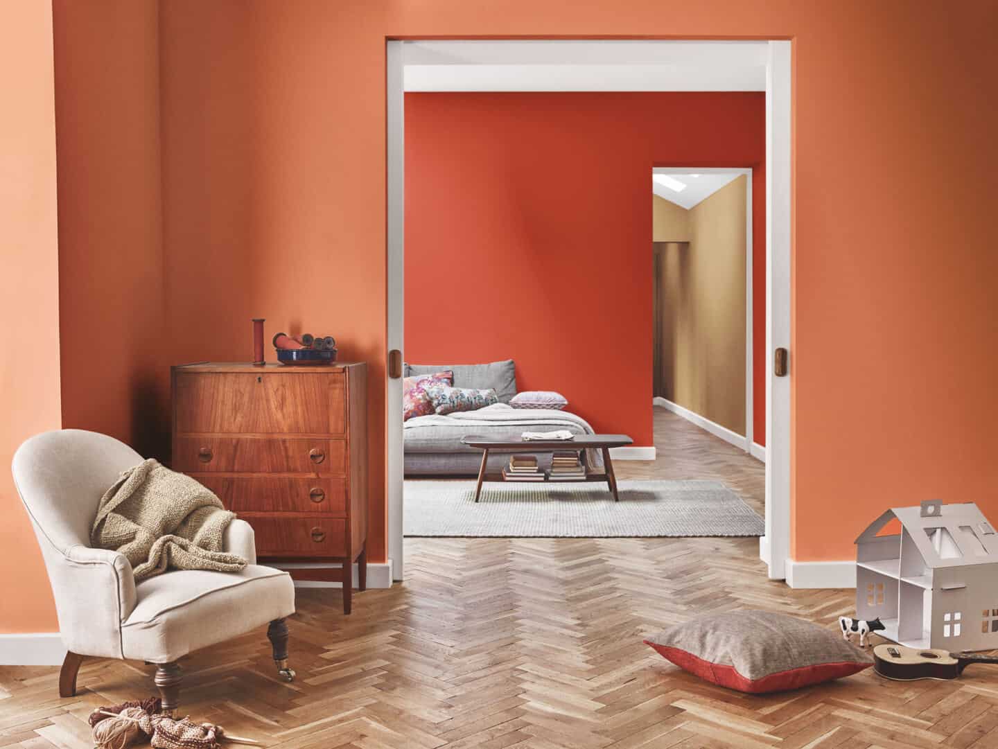 Autumnal Hues in interiors - Dulux colour of th eyear 2019 spiced honey  painted on a wall that is visible through two doorways.