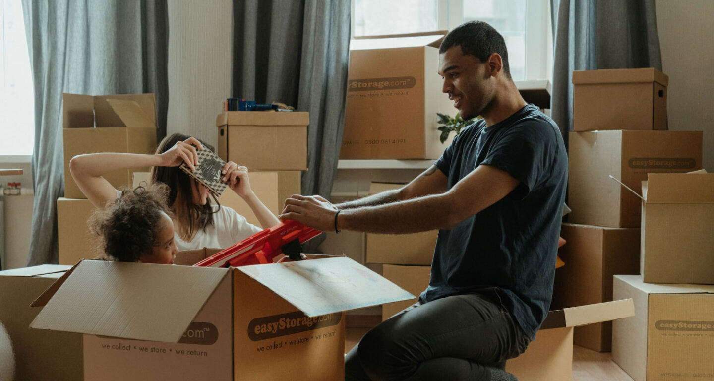 A family unpacking their belongings in their new home