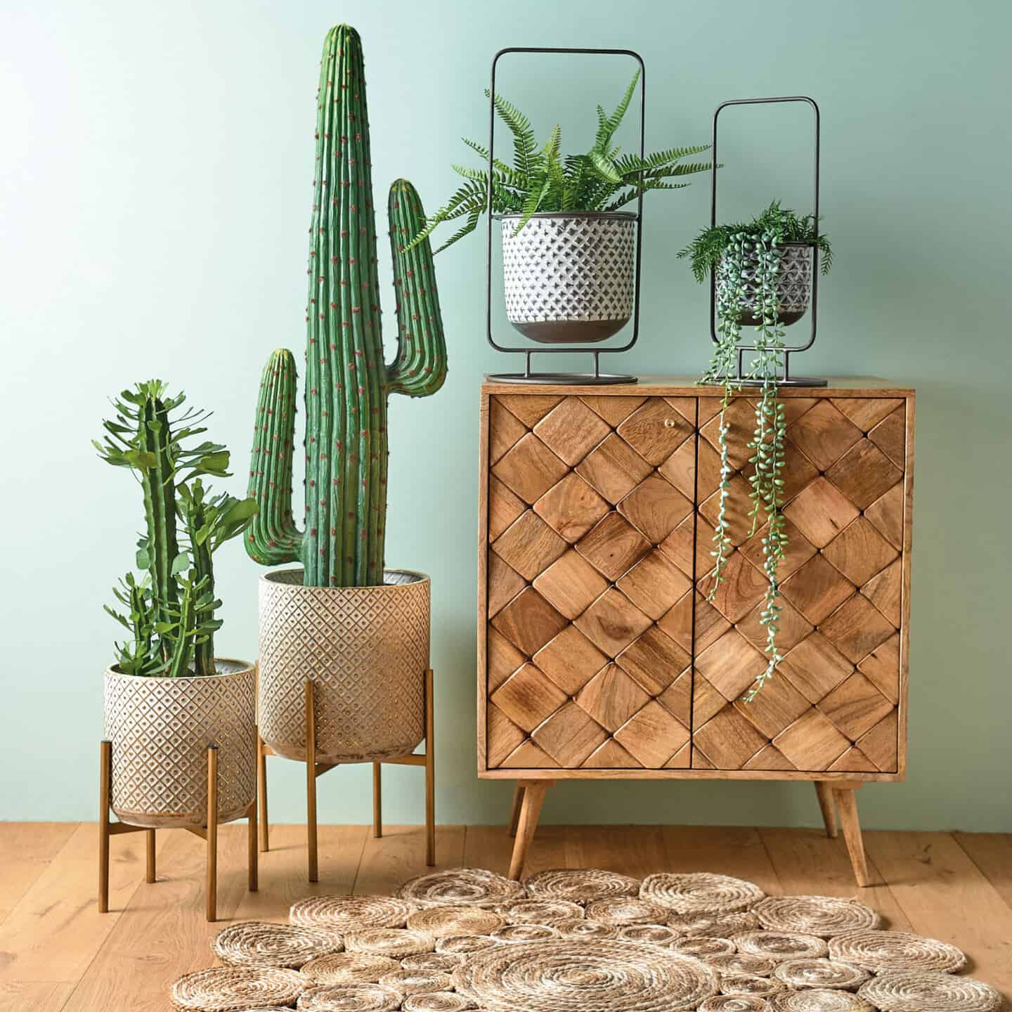 Bringing Natural Elements into the Home. Living room and  featuring a wooden sideboard and plants behind a seagrass rug