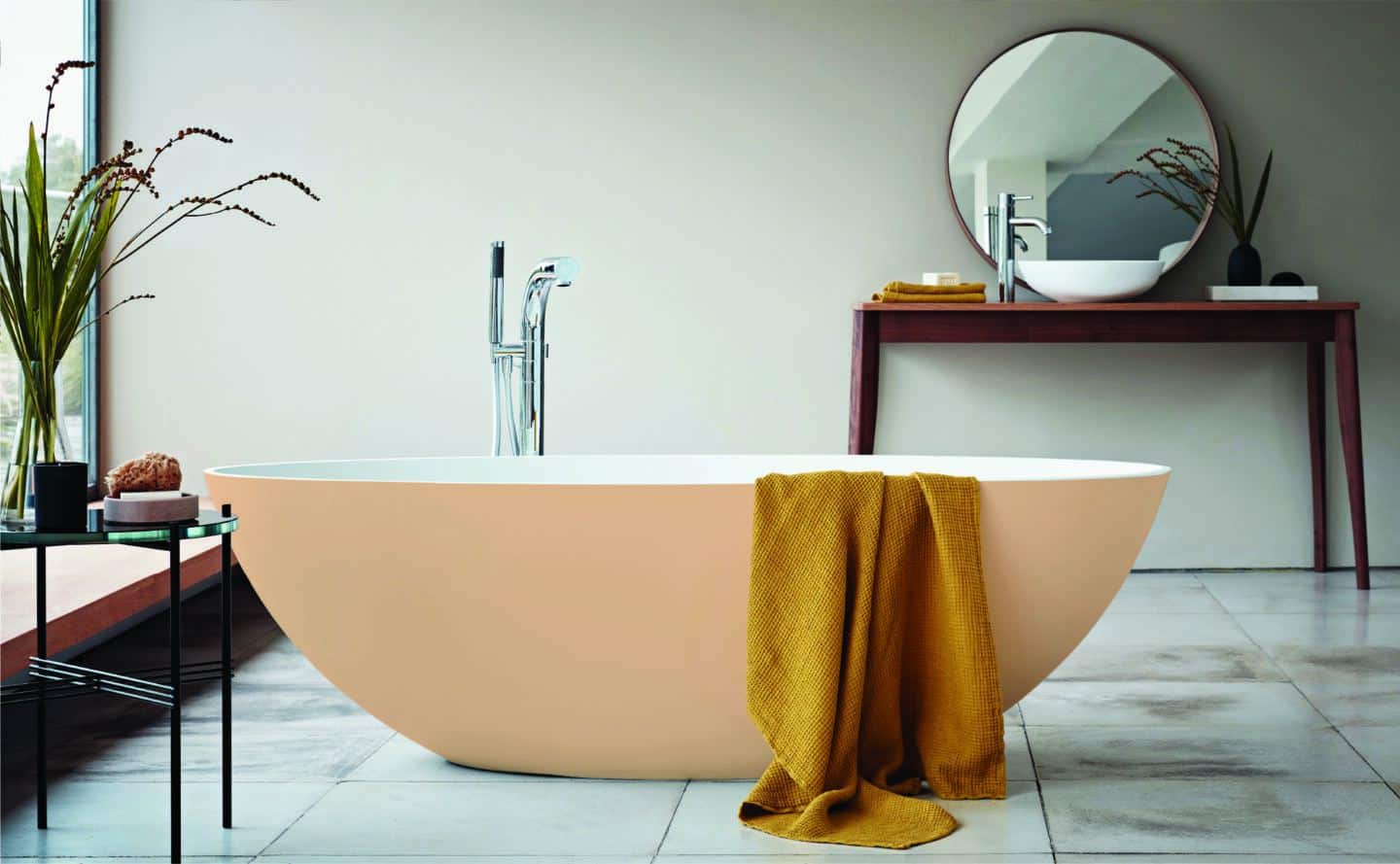 A peach freestanding bathtub from Waters Baths of Ashbourne