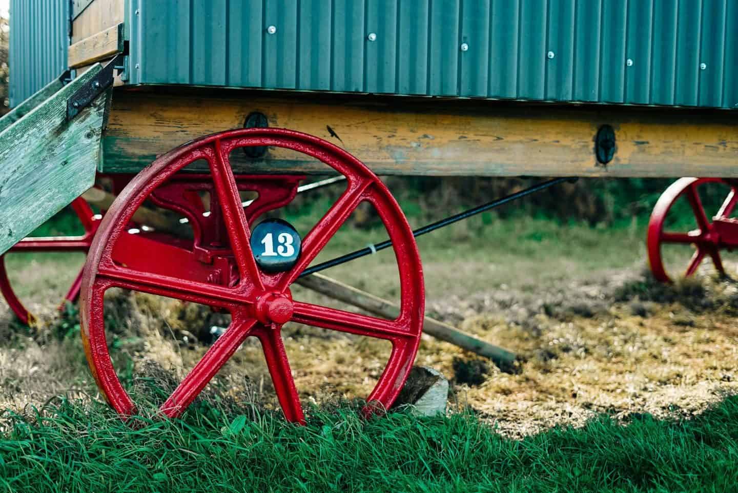 enamel house signs by Ramsign. Number 13 perched on a wagon wheel