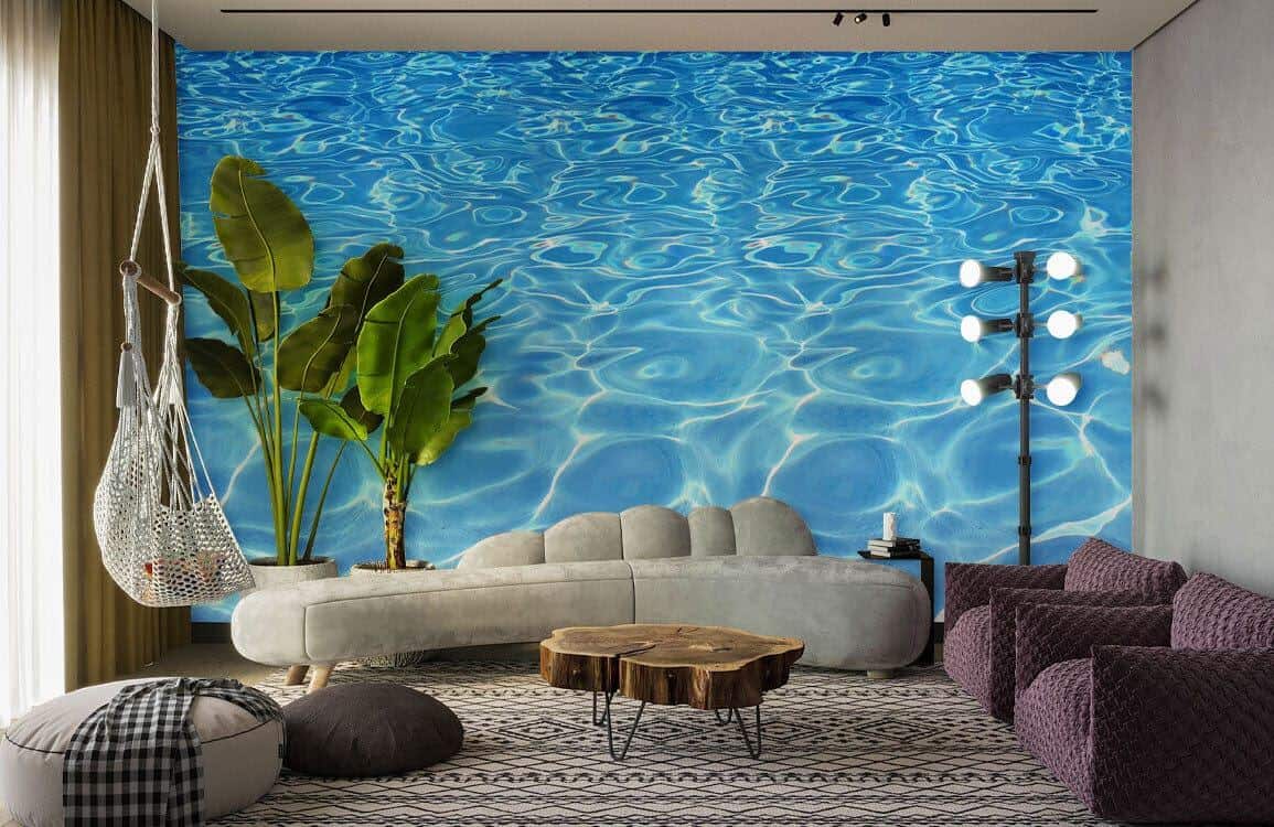 Wallpaper mural of reflections on rippling water behind a minimalist grey sofa and wooden coffee table