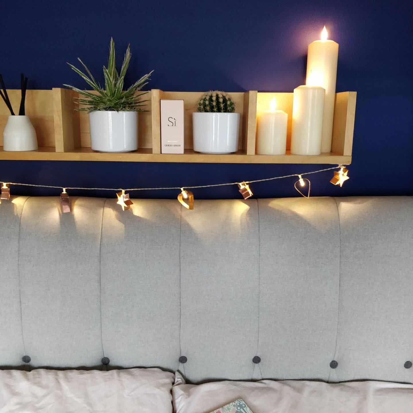 Realistic LED candles from Candled on a bedroom shelf