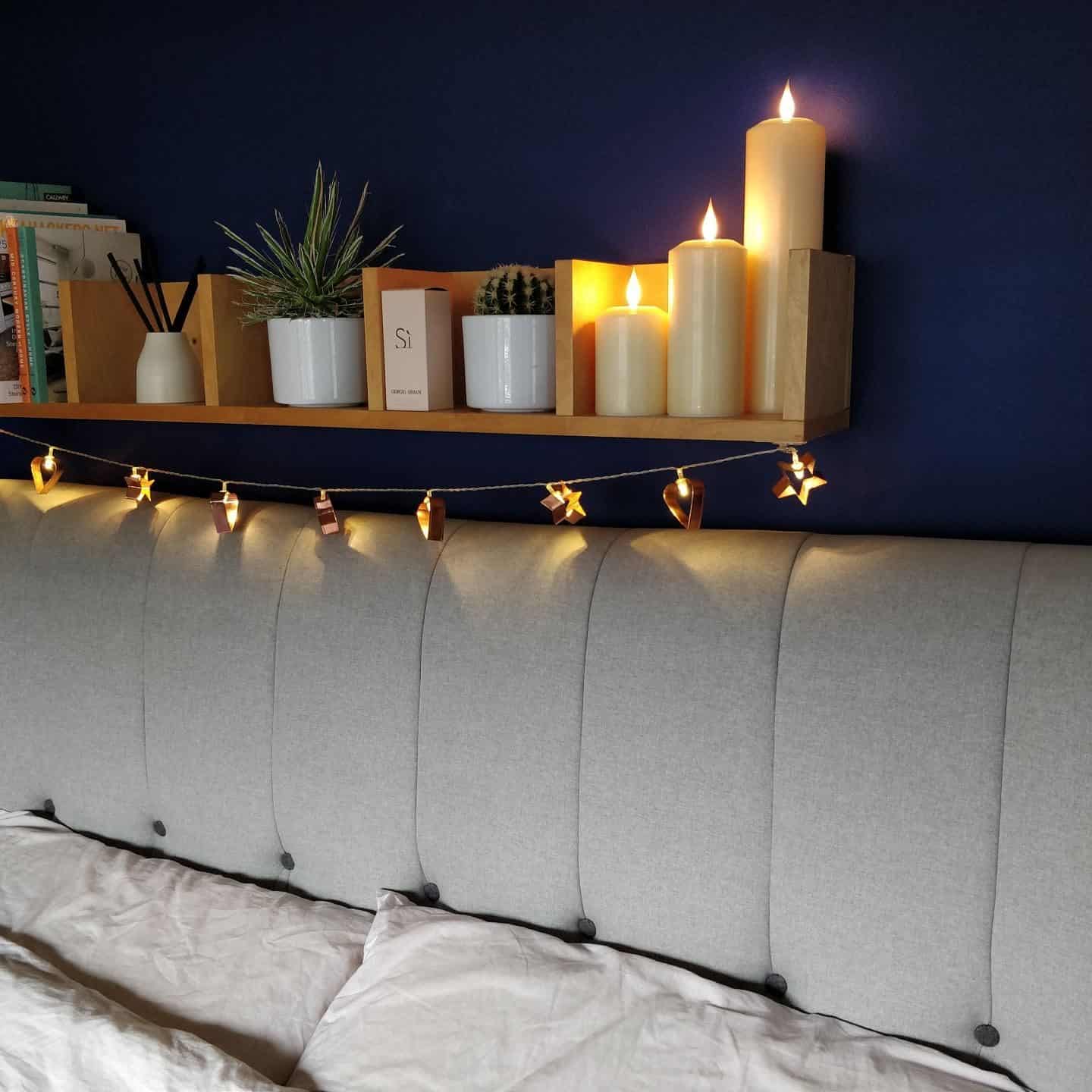 Realistic LED candles from Candled on a bedroom shelf 4