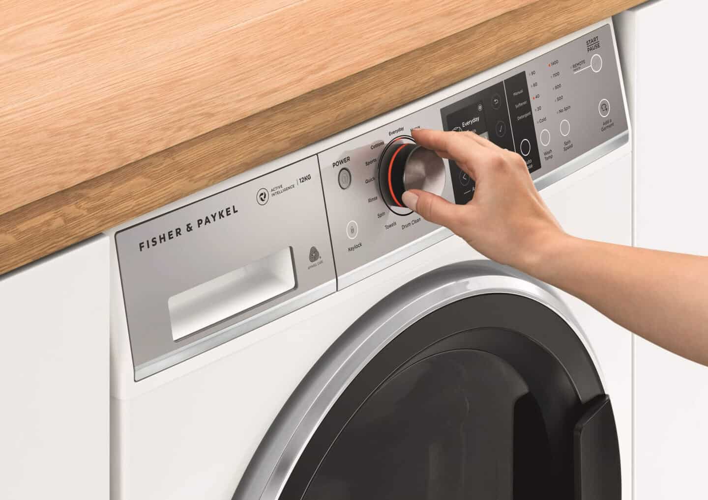 A woman using an eco-friendly washing machine from Fisher & Paykel