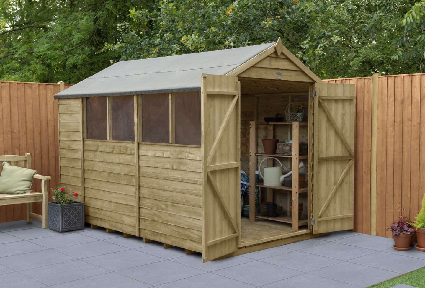 A garden shed on a patio used to store gardening equipment