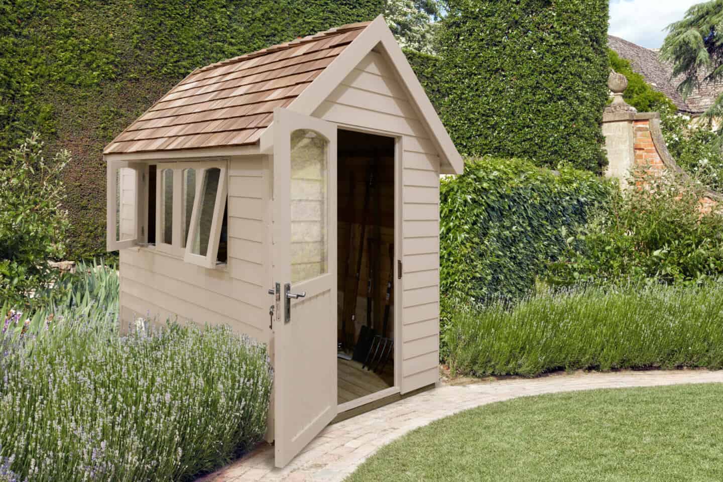 A potting shed in the corner of a large garden