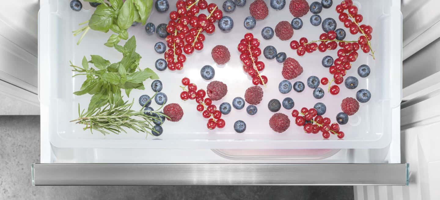 Liebherr's fully integrated appliance range. A freezer drawer full of berries and herbs.