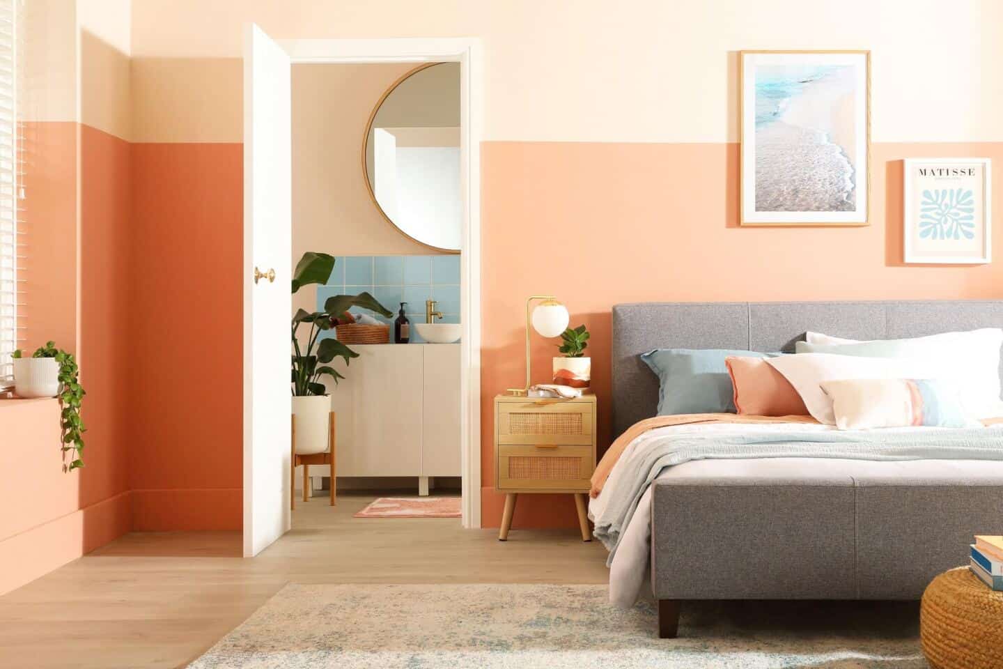 A bedroom featuring peach paint on the walls