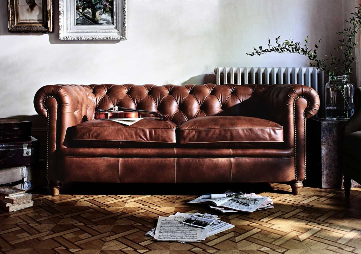 Chesterfield sofa style in a living room with parquet flooring and white walls